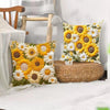 A decorative cushion cover featuring a floral pattern of yellow and white sunflowers on a woven straw cushion.