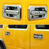 Close-up view of chrome door handle covers for a yellow Hummer H2 vehicle.
