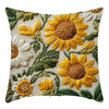 A fabric cushion cover featuring embroidered sunflowers in shades of yellow, cream, and green.