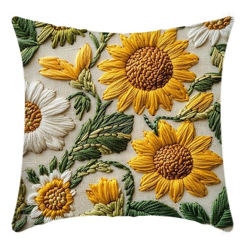 A fabric cushion cover featuring embroidered sunflowers in shades of yellow, cream, and green.