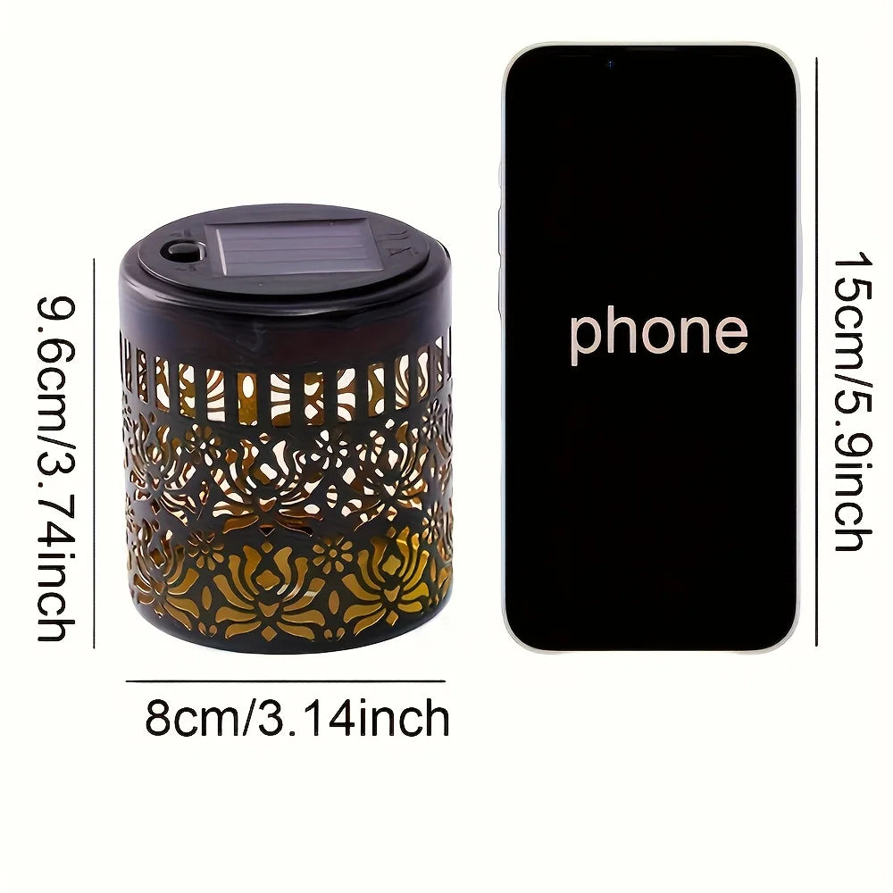 A decorative solar peony wall light with a dark base and intricate gold-colored cutout pattern, shown next to a smartphone fo
