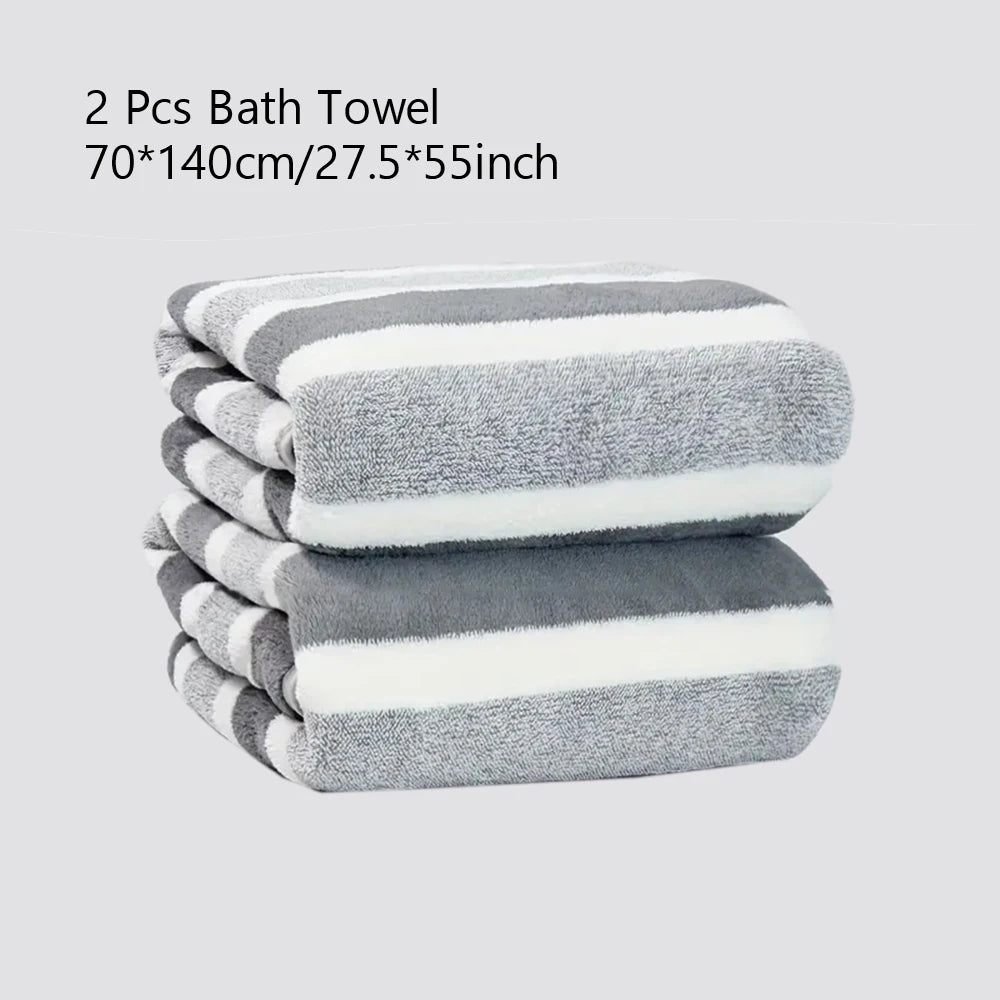 A stack of two gray and white striped bath towels is shown.