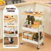 A white 3-tier rolling utility cart with a wooden top and storage baskets is shown on a kitchen counter.