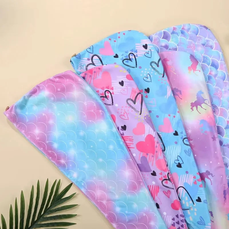 A collection of colorful microfiber hair drying towel wraps featuring hearts and patterns.