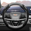 A close-up view of a glossy carbon fiber steering wheel cover inside a car cockpit.
