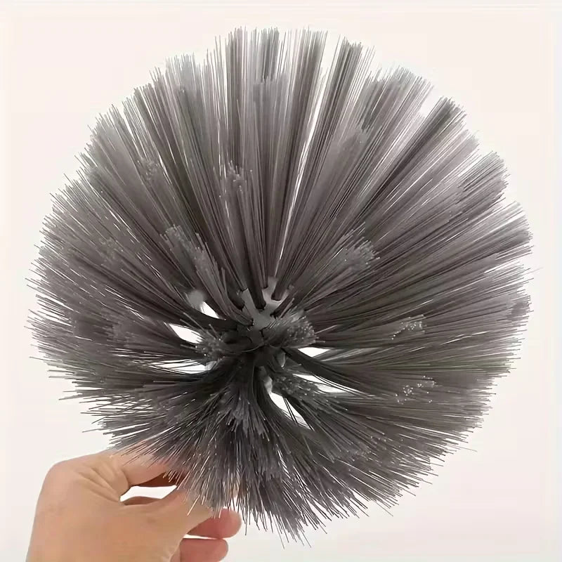 A hand holds an adjustable spider web ceiling cleaner with a microfiber head, showing the bristled gray cleaning tool.