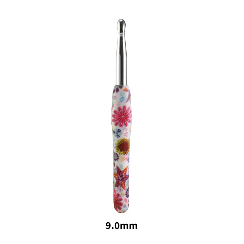 A silver ergonomic crochet hook with a colorful sunflower design, measuring 9.0mm.