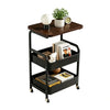 A black 3-tier rolling utility cart with a wooden top holding a potted plant and a clock.