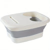 A white and gray collapsible foot spa bucket with a removable insert for massage nodules.