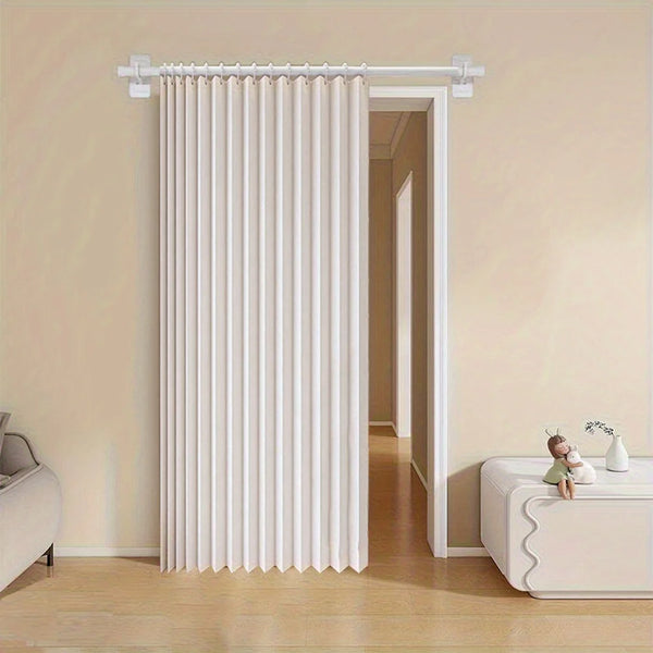 White vertical pleated curtain installed on a white rod in a room doorway.