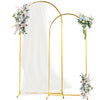 Gold metal wedding arch backdrop stand with a sheer white drape and floral arrangements