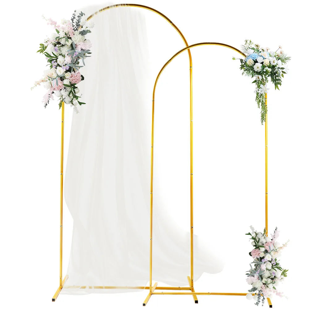 Gold metal wedding arch backdrop stand with a sheer white drape and floral arrangements