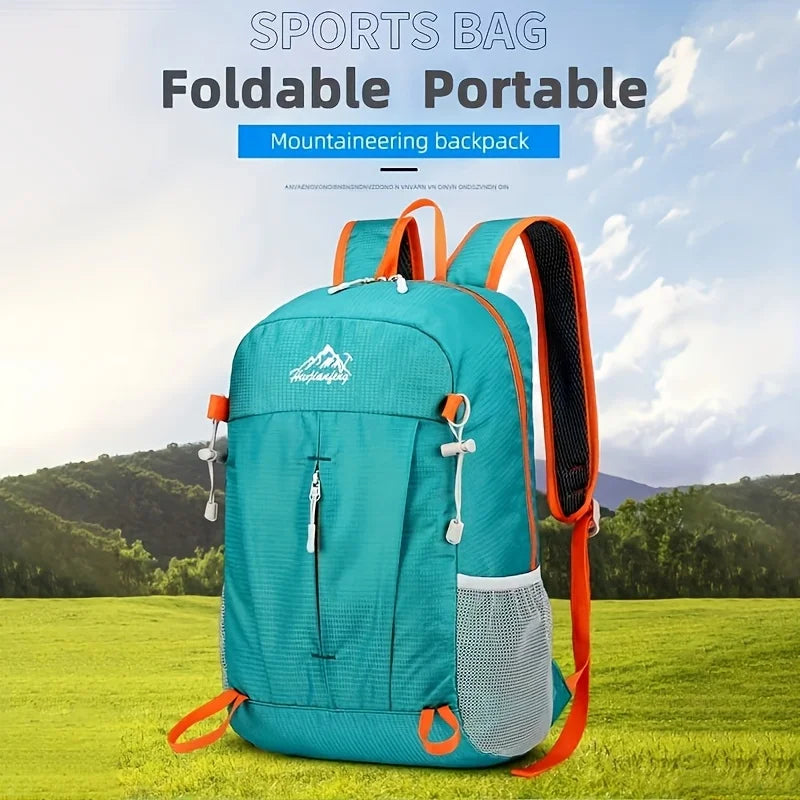 A teal foldable portable mountaineering backpack is shown outdoors on a grassy field.