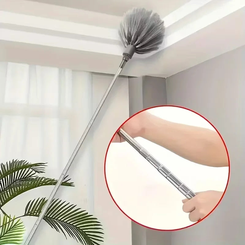 A long, silver adjustable spider web ceiling cleaner with a gray microfiber head is shown against a white ceiling.