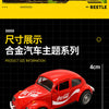 A red die-cast model of a vintage Volkswagen Beetle car.