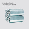 A set of two light blue and white striped bath towels folded on a surface.