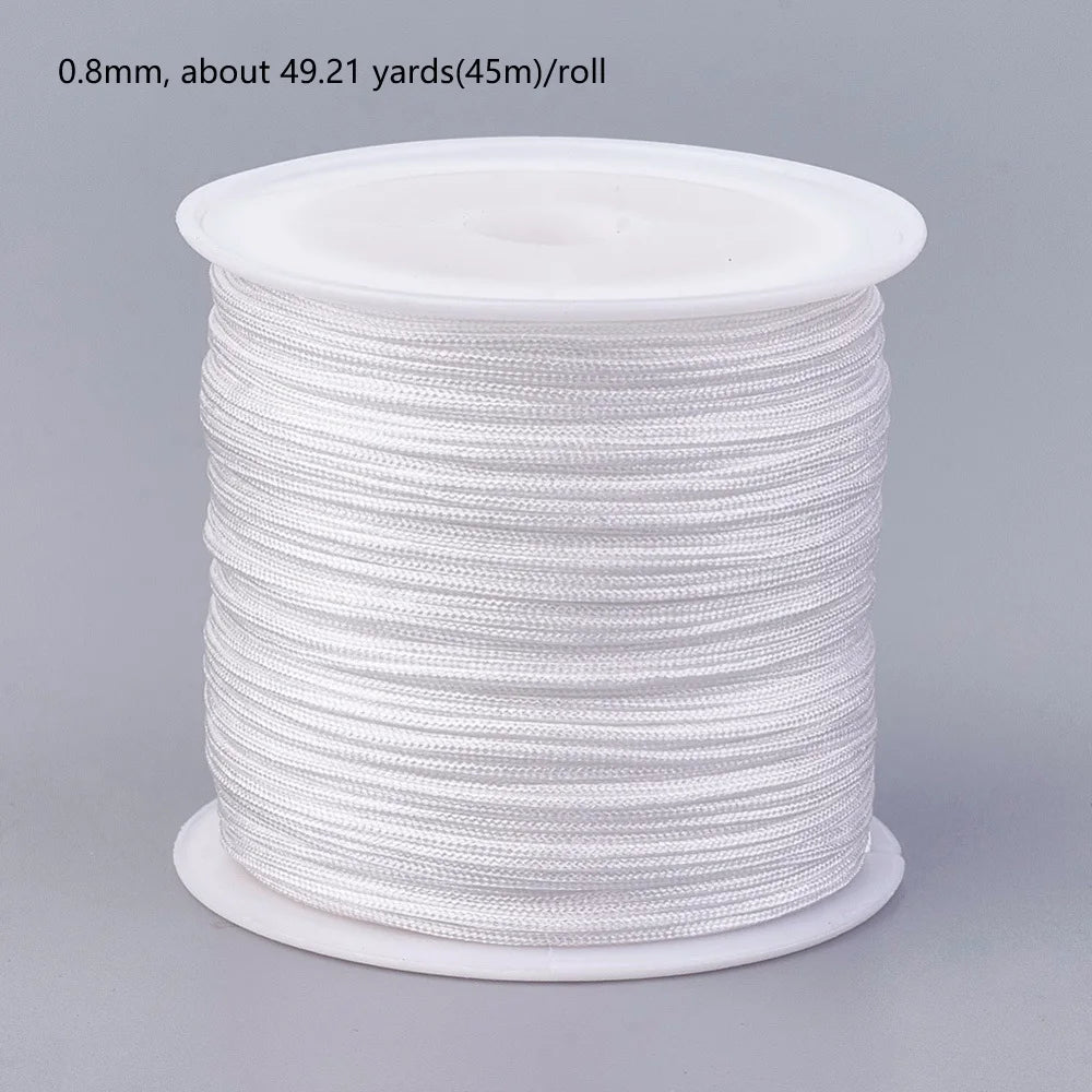 A roll of 0.8mm white nylon cord for jewelry making and crafting.