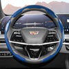 Close-up view of a black steering wheel with blue and black carbon fiber accents and an airbag cover.