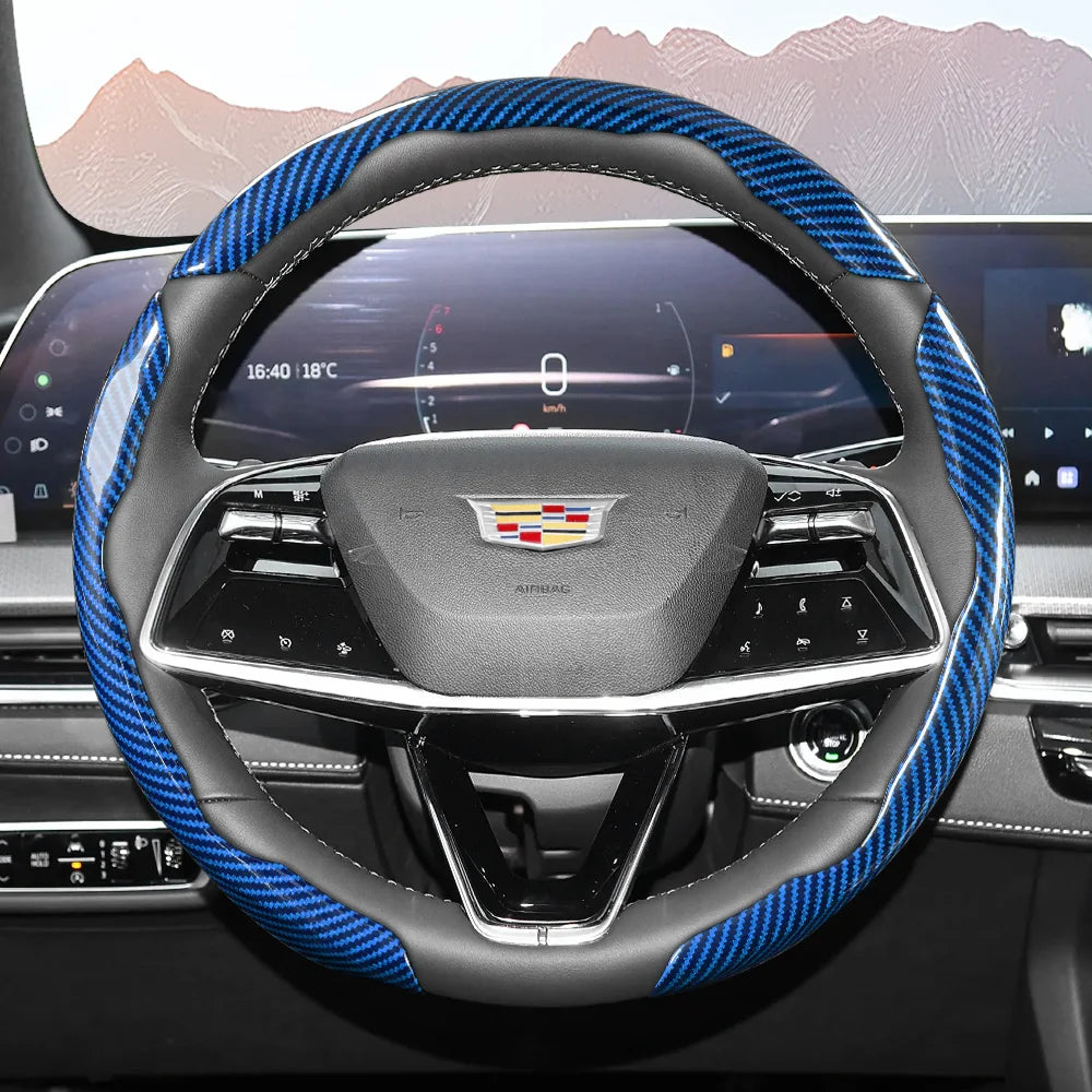 Close-up view of a black steering wheel with blue and black carbon fiber accents and an airbag cover.
