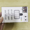 A white box for a LED cube light with clip and a selfie light.