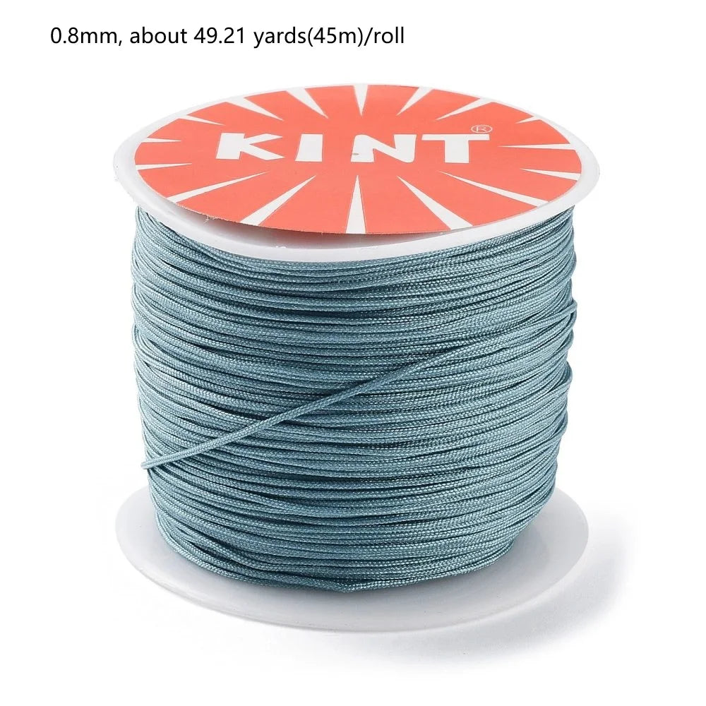 Roll of 0.8mm red nylon cord for jewelry making and crafting labeled KINT
