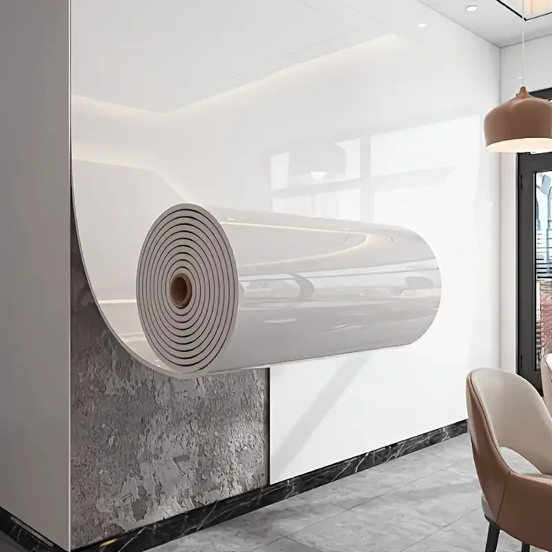 A roll of self-adhesive marble wallpaper in white and gray spiral pattern mounted on a wall.