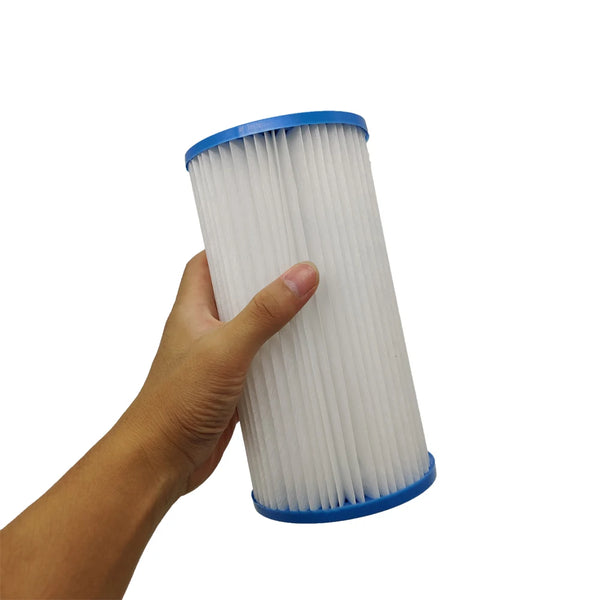 A hand is holding a white pool filter cartridge with a blue cap.