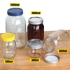 A collection of four glass mason jars with airtight lids, labeled by volume (500ml, 1000ml, 2000ml, and 300ml), displayed on 