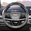 A close-up view of a glossy carbon fiber steering wheel cover inside a car cockpit.
