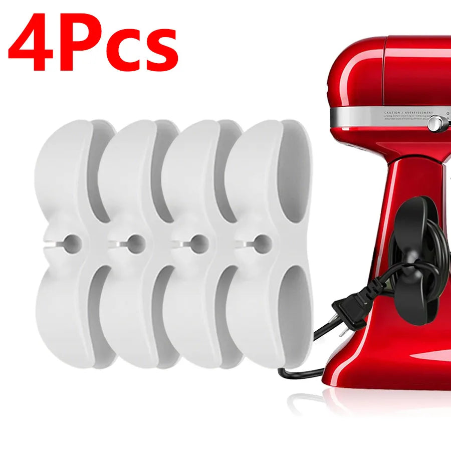 Four white adhesive cord organizers for kitchen appliances shown next to a red appliance.