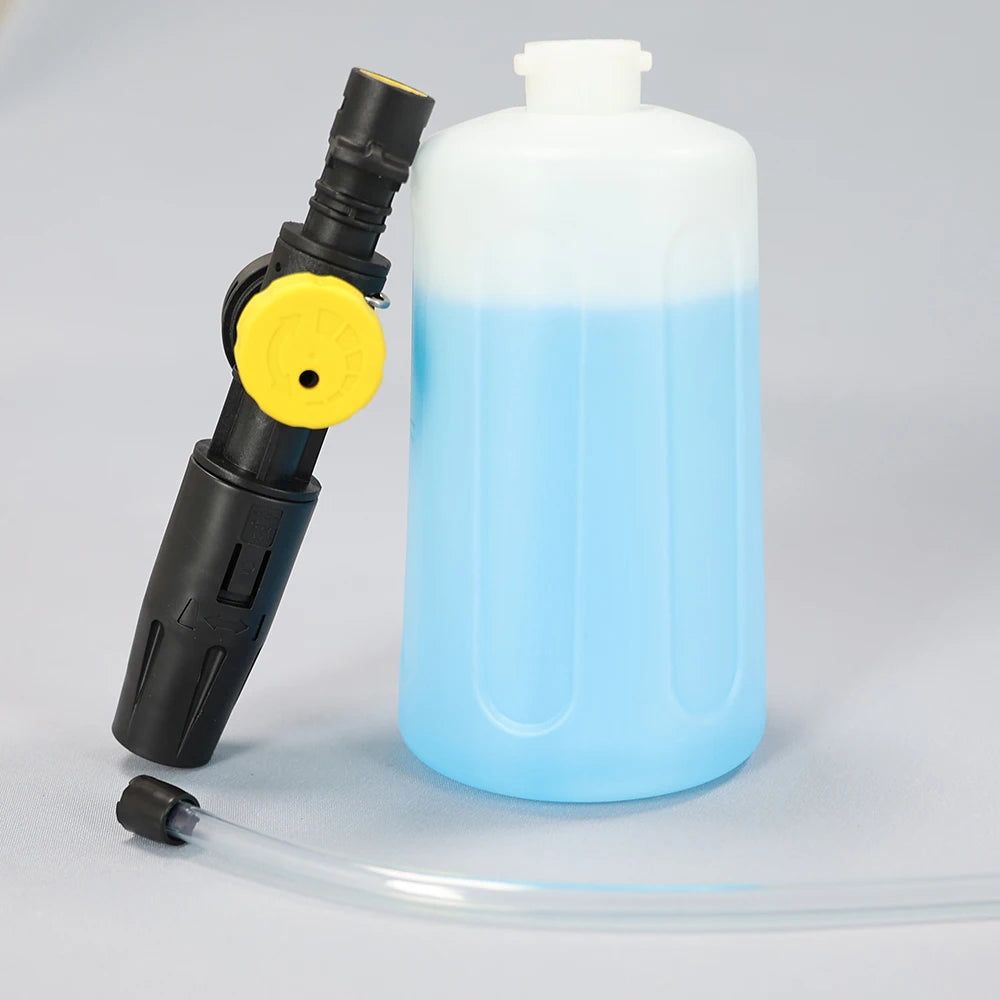 A clear plastic bottle filled with blue liquid next to a black foam cannon with a yellow nozzle.