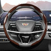 Close-up view of a glossy carbon fiber steering wheel cover inside a car cockpit.