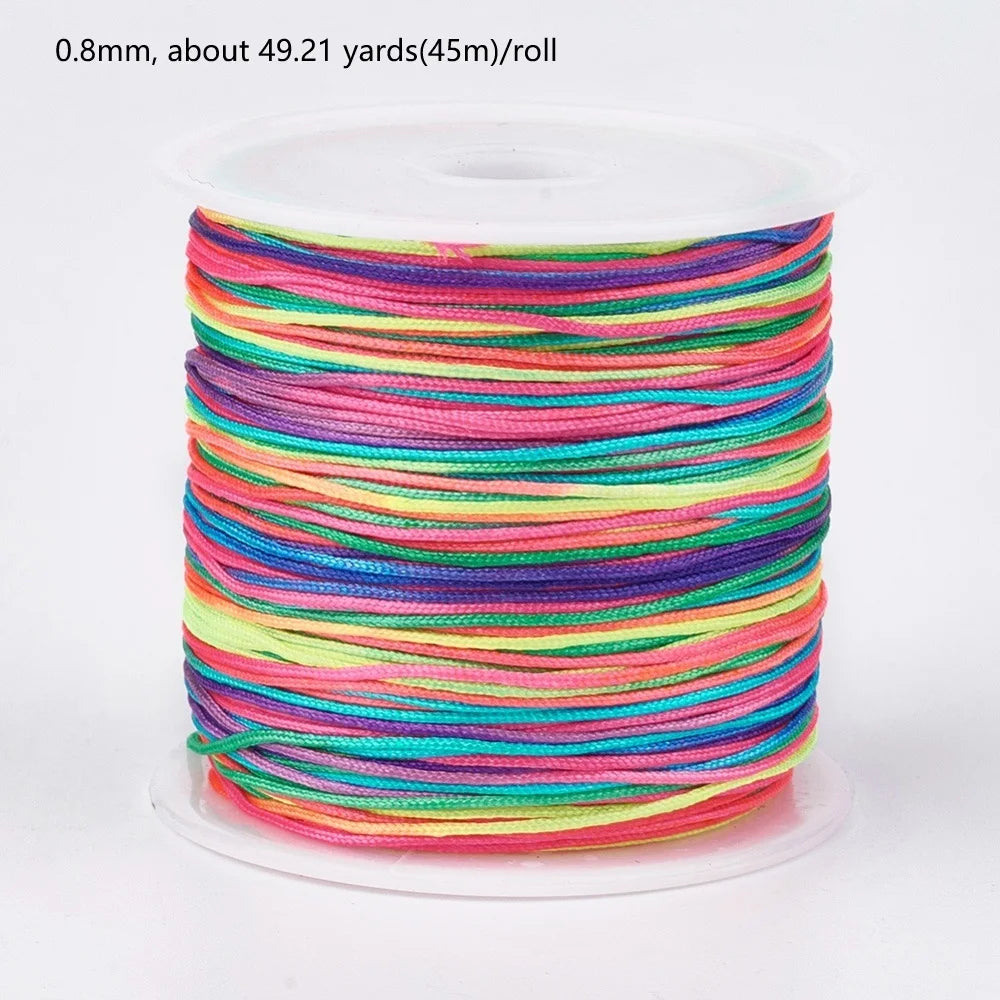 A roll of 0.8mm red nylon cord for jewelry making and crafting, featuring multiple bright colors.