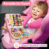 A smiling toddler holds a pink felt activity book for sensory learning and travel.