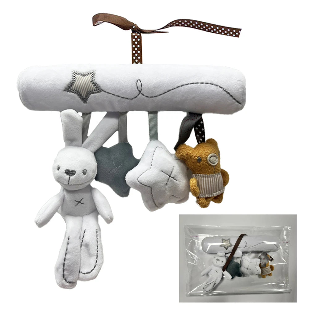 A soft plush bunny rattle toy with a brown ribbon, featuring a bunny figure and a star shape.