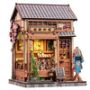 A detailed miniature Japanese book nook kit featuring a traditional wooden storefront with intricate details and lighting.
