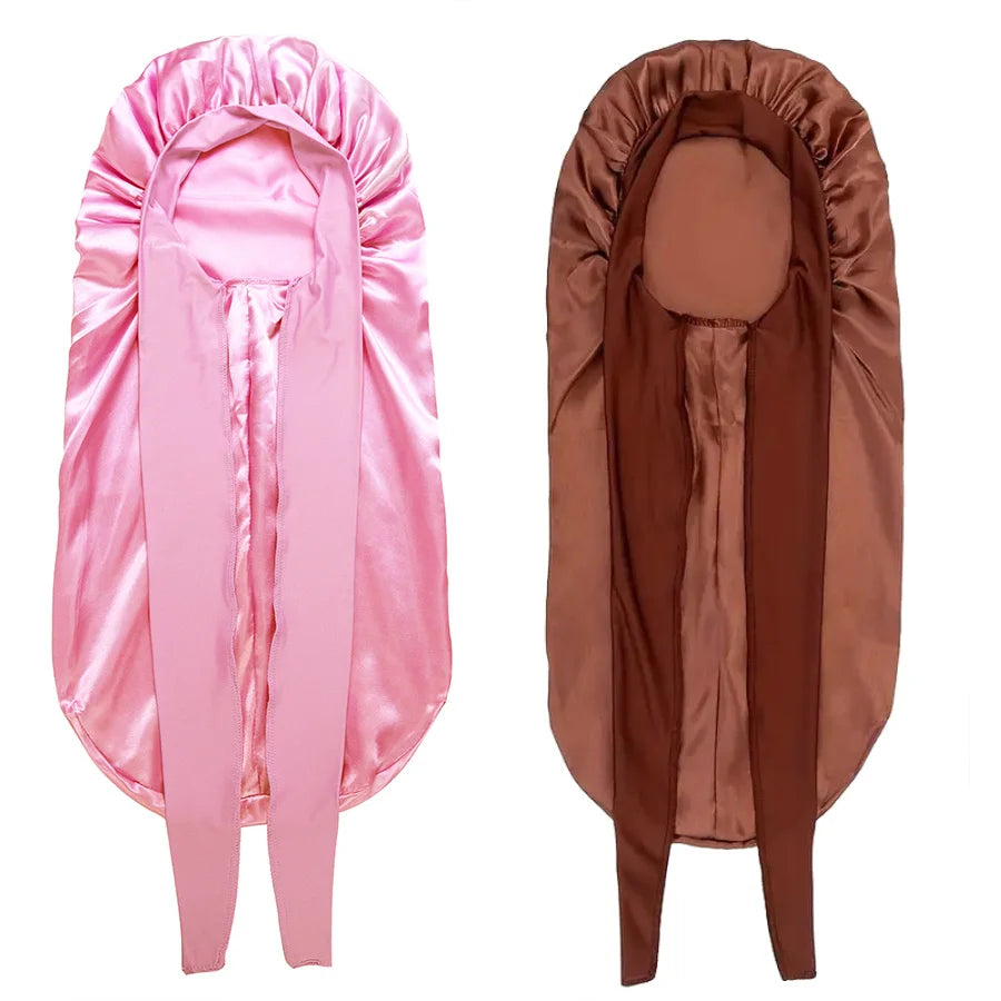 Ein Paar satinierte Schlafbonnets in rosa und braun für lockiges Haar