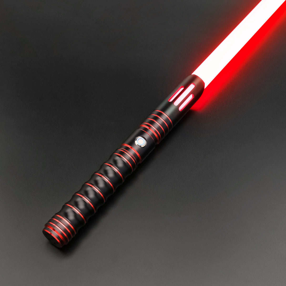 A close-up of a Neo Pixel lightsaber with a red blade and black hilt against a dark background.