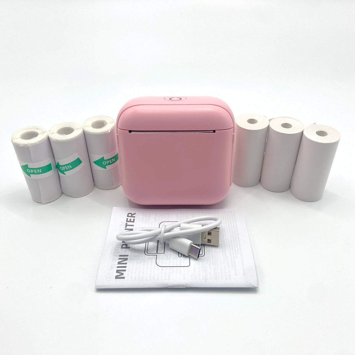 Imprimante thermique Bluetooth rose portable avec plusieurs rouleaux de papier blanc et un câble d'alimentation.