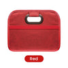 A red foldable car trunk organizer with carry handles.