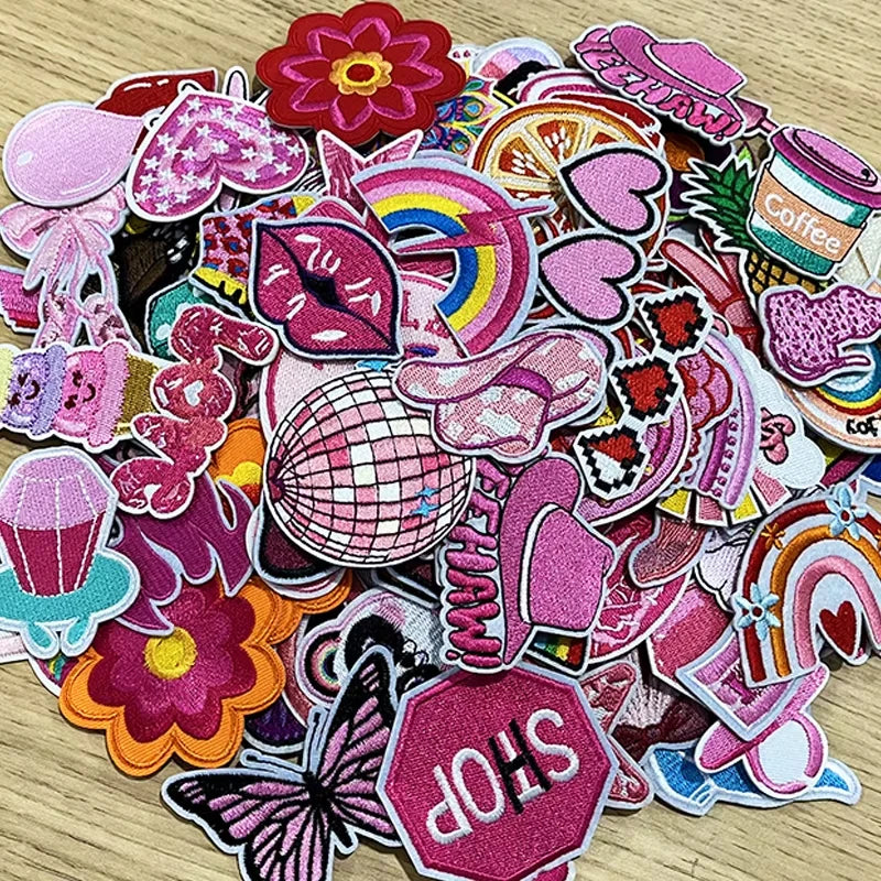 A collection of pink themed embroidered cartoon iron-on patches featuring various shapes and designs.