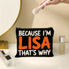 A black canvas makeup bag with orange text that reads Because I'm Lisa That's why, next to a cosmetic brush and a glass jar.