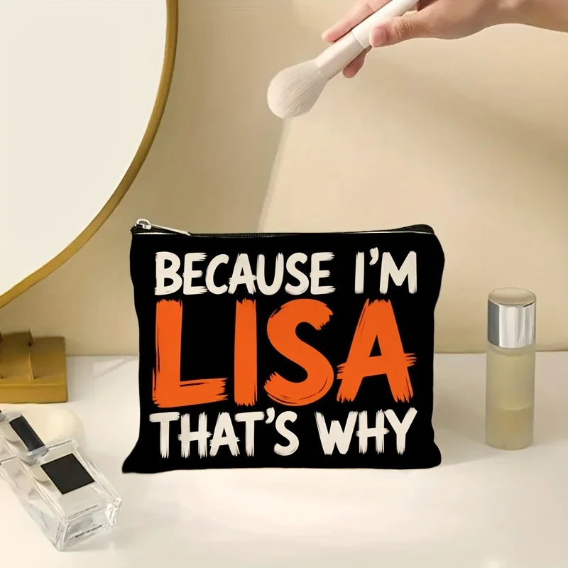 A black canvas makeup bag with orange text that reads Because I'm Lisa That's why, next to a cosmetic brush and a glass jar.