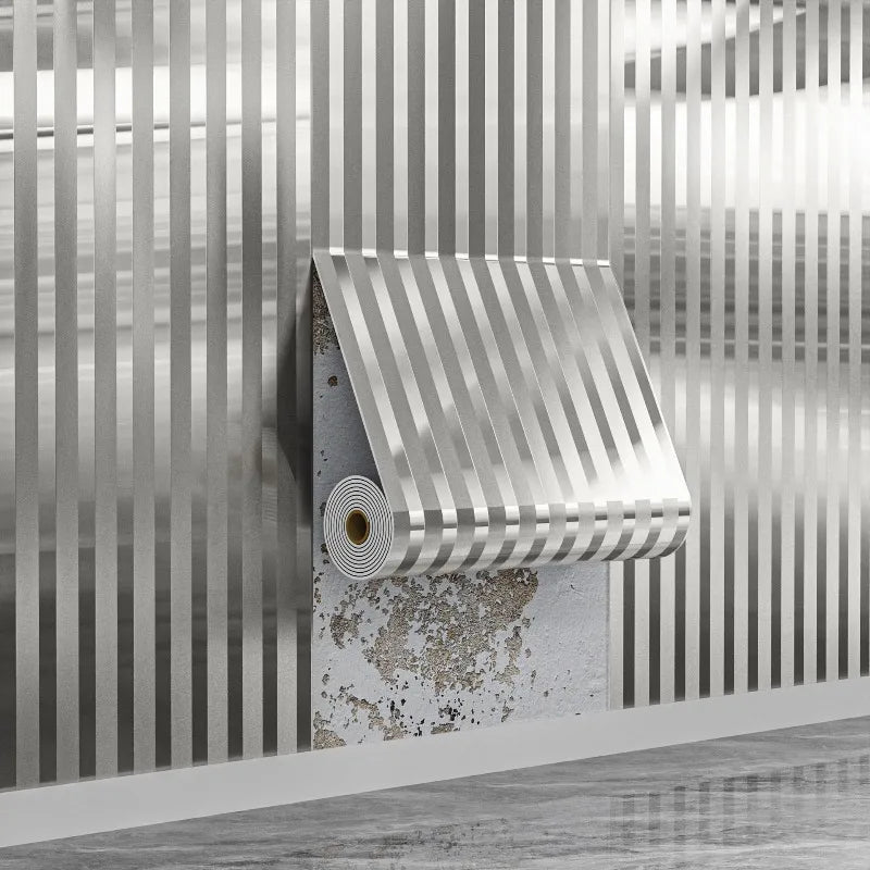 A close-up of a self-adhesive wood grain grille wall sticker in silver tones mounted on a textured wall.