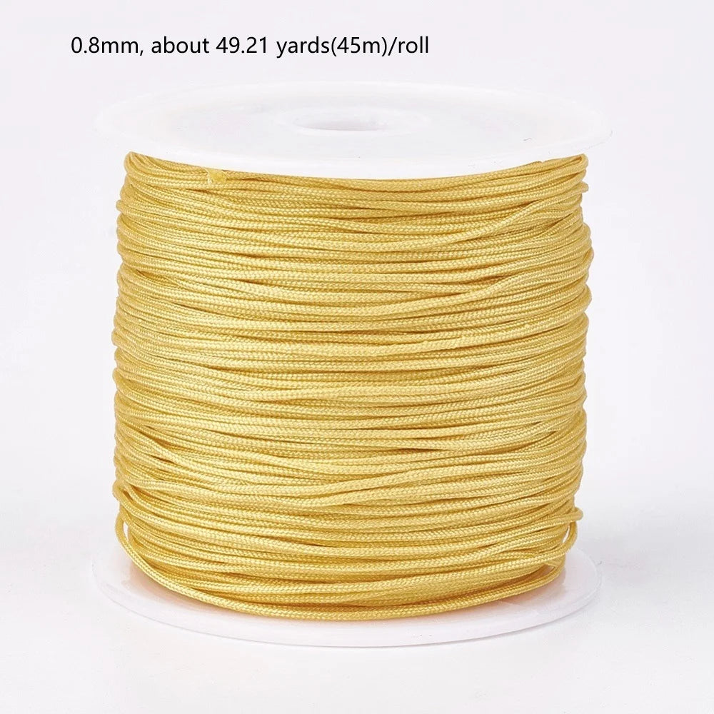 A roll of 0.8mm red nylon cord for jewelry making and crafting.