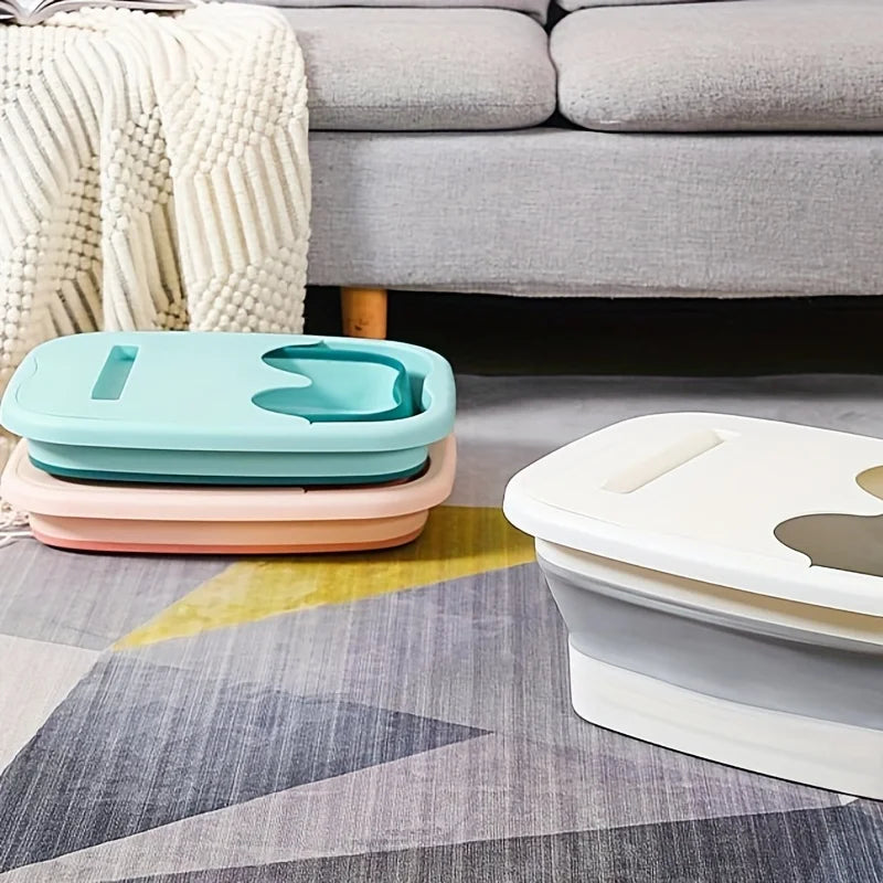 Two collapsible foot spa buckets in mint green and pink resting on a gray patterned rug.