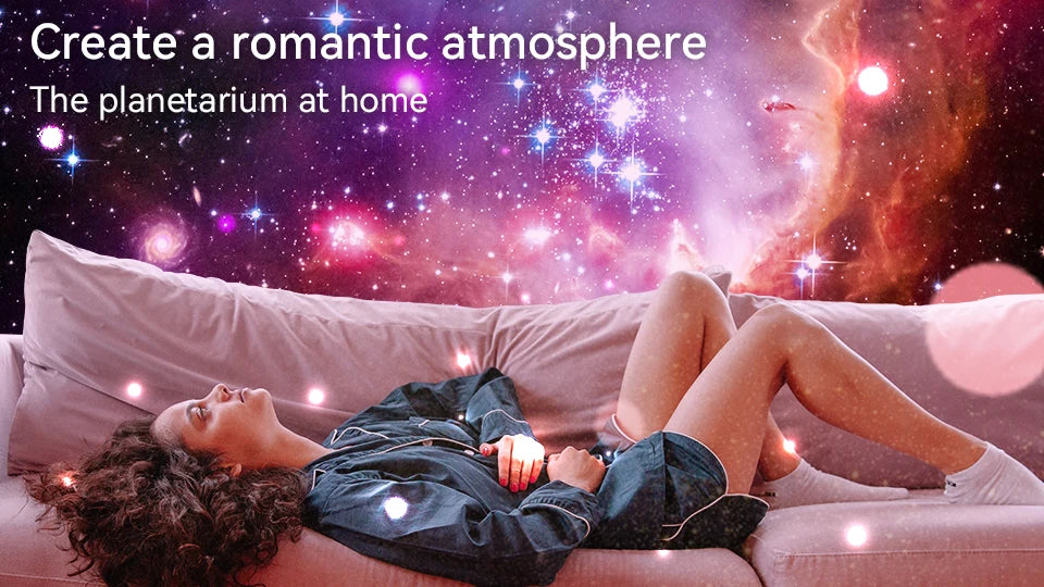 A woman relaxing on a couch looking up at a vibrant galaxy and star field projected onto the room.