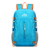 A bright blue ultra-light foldable travel backpack with orange accents and a gray mesh bottom.
