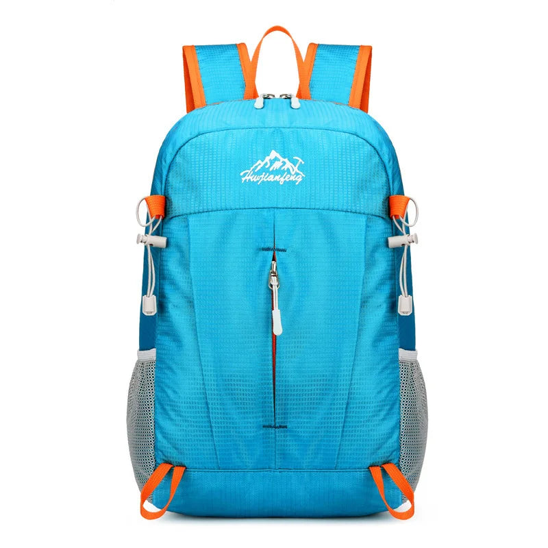 A bright blue ultra-light foldable travel backpack with orange accents and a gray mesh bottom.