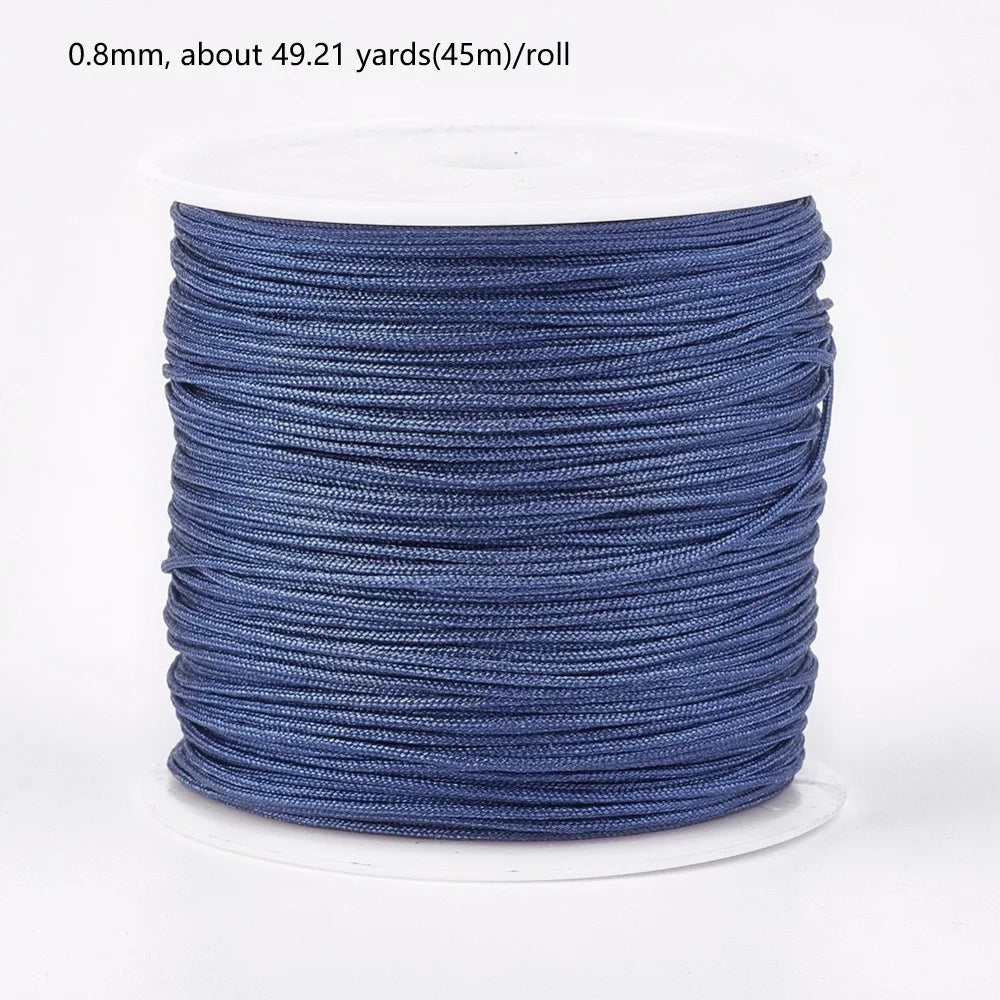 A roll of 0.8mm blue nylon cord for jewelry making and crafting.